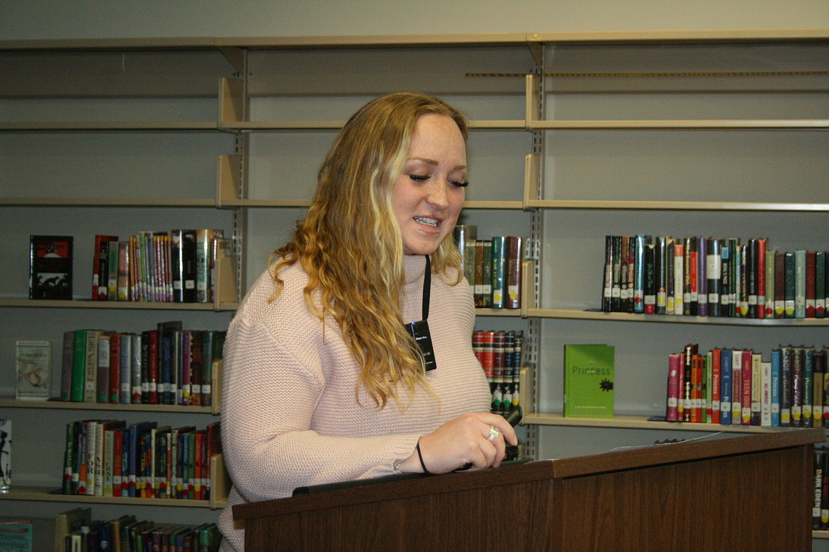 Quincy School District director of bands Devan Chandler updates the Quincy School Board on donations that will allow Quincy High School to purchase new band uniforms.