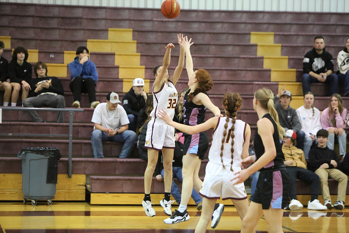 With a defender in her face, Moses Lake sophomore Madison Bond (32) shoots one of her three-straight made three-pointers in the third quarter of the Maverick’s win over West Valley (Yakima). Bond finished with a team-high 14 points in the win.