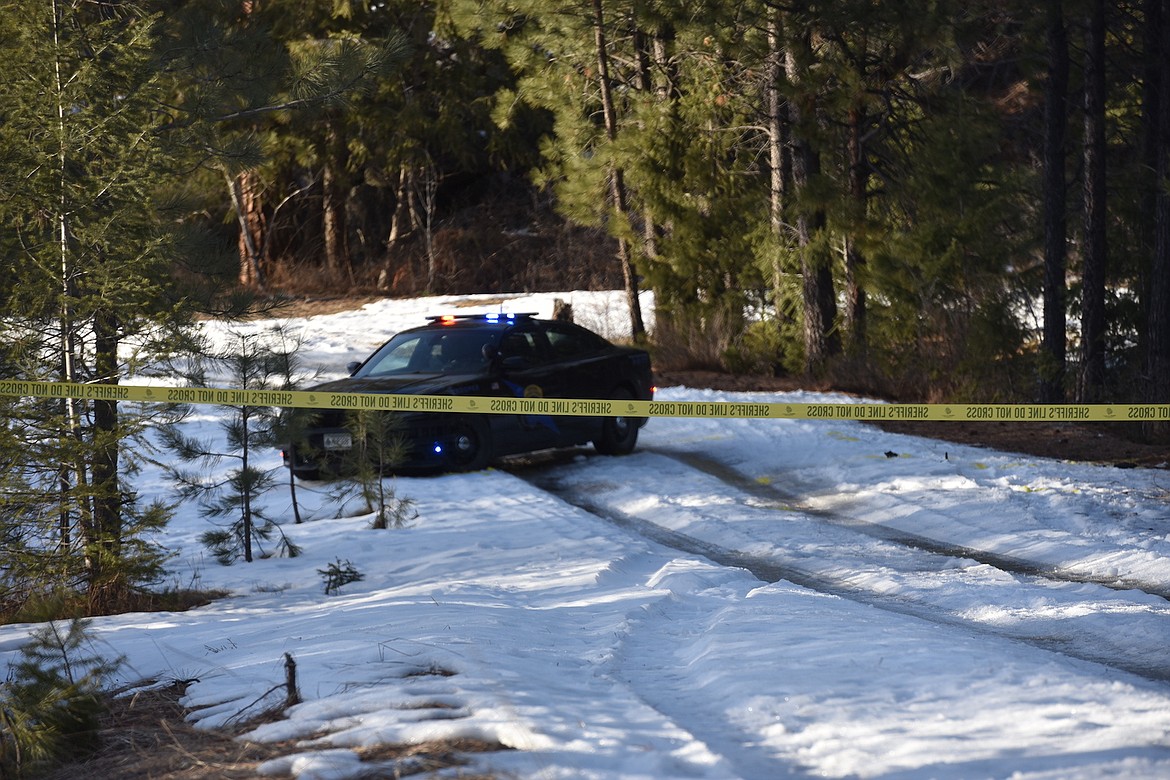 Crime scene tape is strung across a forest road at the scene of police chase on Montana Highway 37 that ended with a Montana Highway Patrol trooper being struck by the suspect vehicle. (Scott Shindledecker/The Western News)