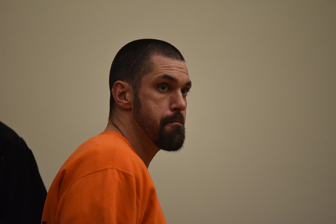 Derrick James Jackson approaches the defendant's table in Flathead County District Court for his Thursday, Feb. 16 arraignment. Jackson is charged with two counts of deliberate homicide as well as tampering with or fabricating evidence and criminal possession of dangerous drugs. (Derrick Perkins/Daily Inter Lake)