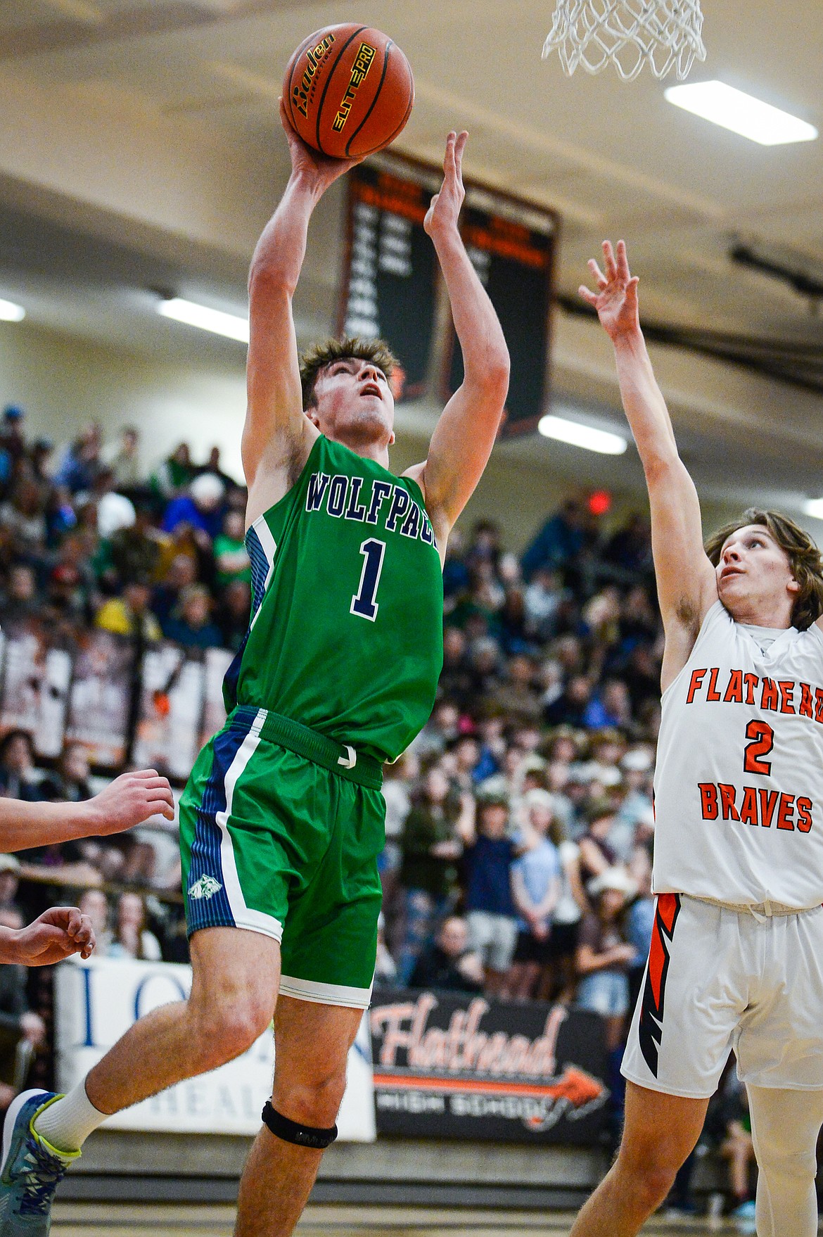 Glacier's Cohen Kastelitz (1) goes to the basket in the first half against Flathead's Joshua Eagleton (2) at Flathead High School on Thursday, Feb. 16. (Casey Kreider/Daily Inter Lake)