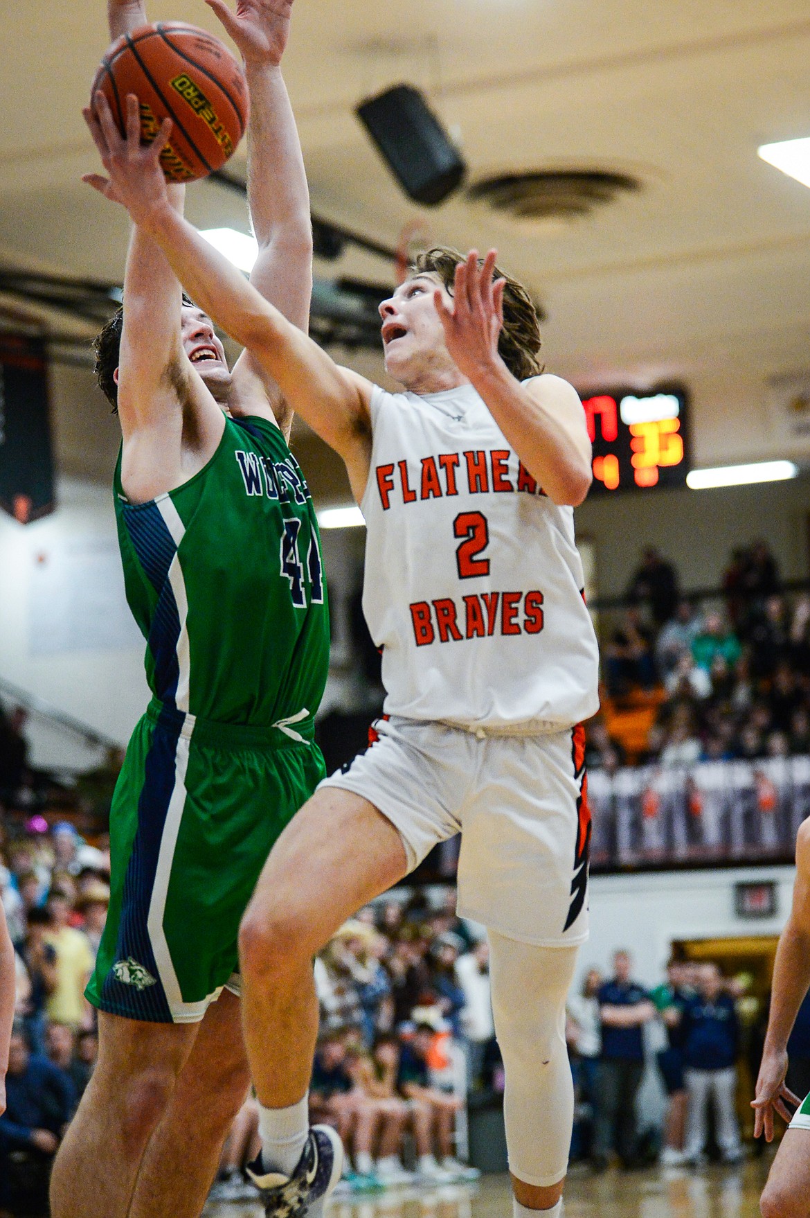 Flathead's Joshua Eagleton (2) drives to the basket against Glacier's Noah Dowler (44) in the second half at Flathead High School on Thursday, Feb. 16. (Casey Kreider/Daily Inter Lake)