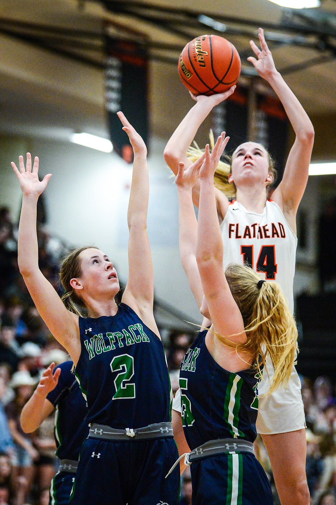 Flathead's Kennedy Moore (14) shoots over Glacier defenders Sarah Downs (2) and Cazzland Rankosky (25) in the second half at Flathead High School on Thursday, Feb. 16. (Casey Kreider/Daily Inter Lake)