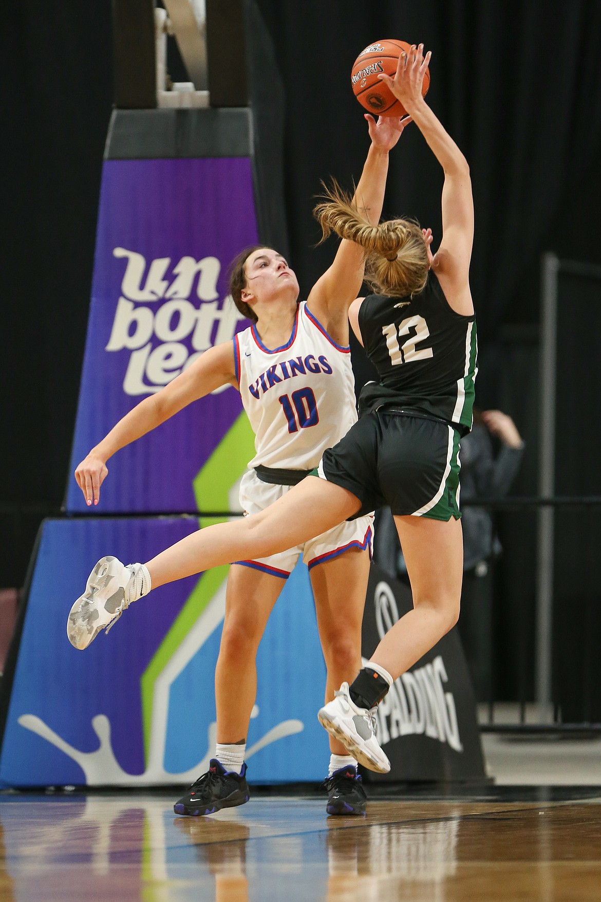 JASON DUCHOW PHOTOGRAPHY
Coeur d'Alene senior Kendall Omlin (10) blocks the shot of Paige Cofer (12) of Eagle in the first round of the state 5A girls basketball tournament Thursday night at the Ford Idaho Center in Nampa.