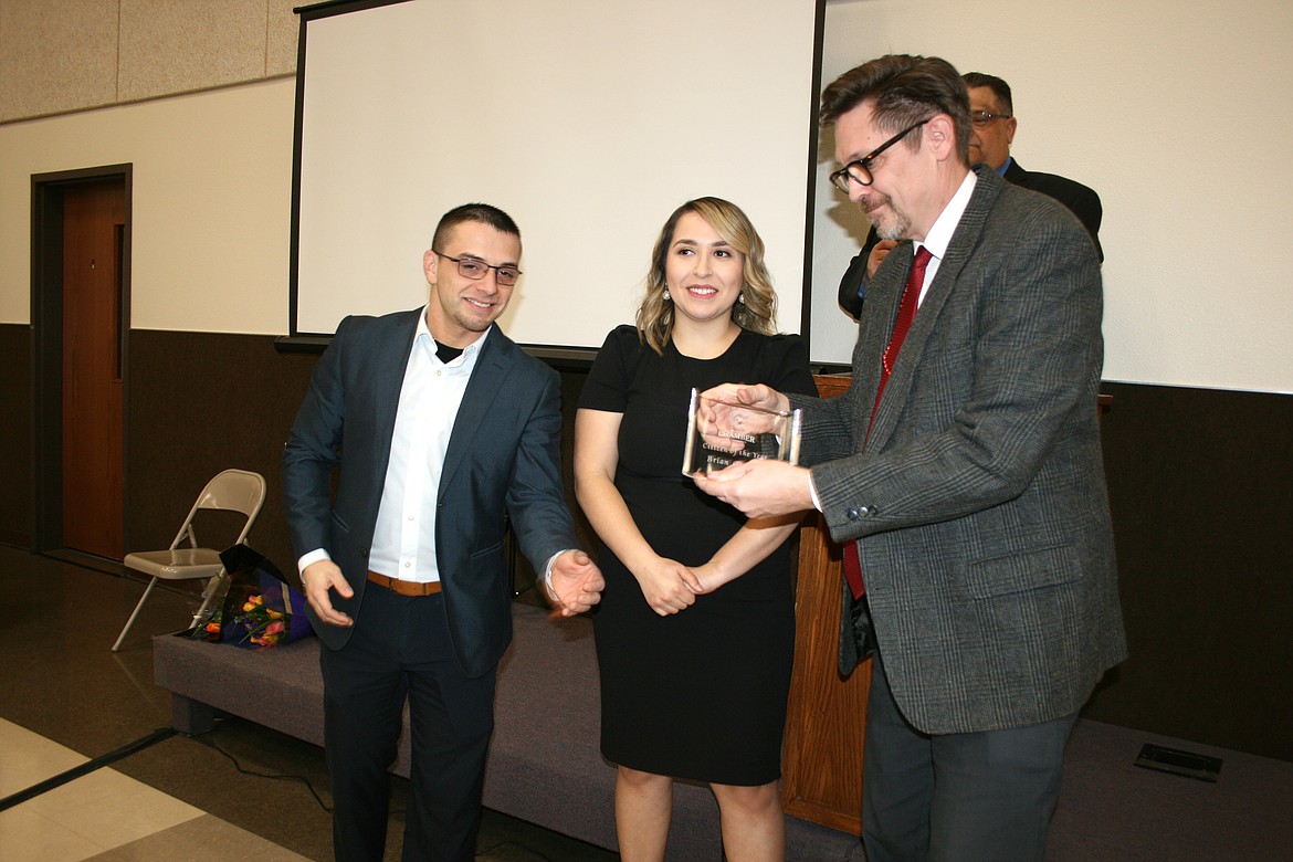 Othello Citizen of the Year for 2022, Brian Gentry, right, displays his award, presented by 2022 Chamber president Mat Garza, left, and 2023 president Thalia Lemus, center, during the 2022 Othello Chamber banquet. The 2023 banquet is Friday.