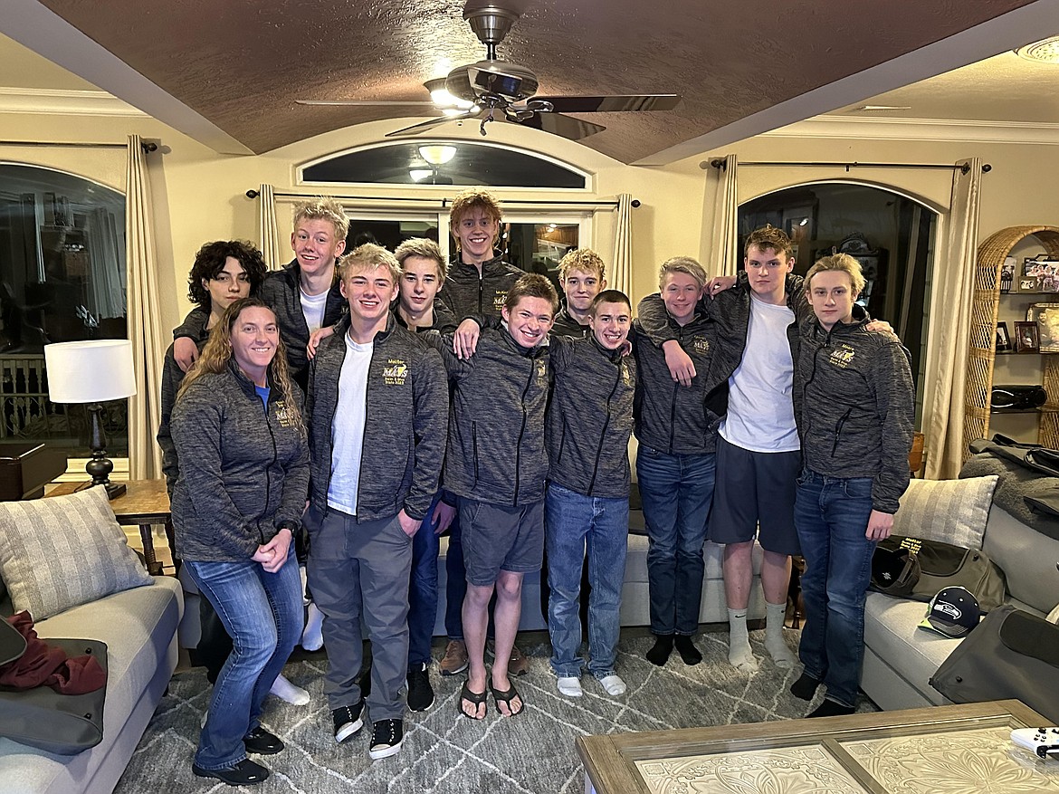 Hanging out with teammates and coaches is Moses Lake junior Danny Thurman’s, center front row, favorite aspect of swimming with the Moses Lake boys swim and dive team.