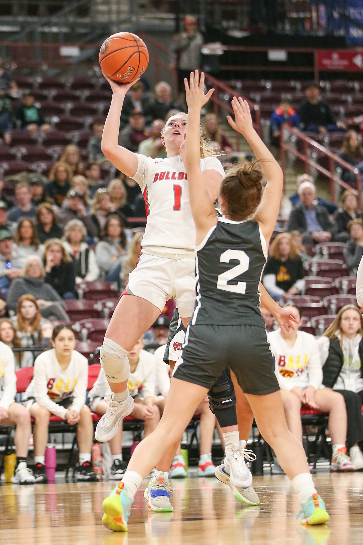 Kelsey Cessna puts up a shot agains Columbia's Ellie Robertson during the 4A semi-final game on Friday night.