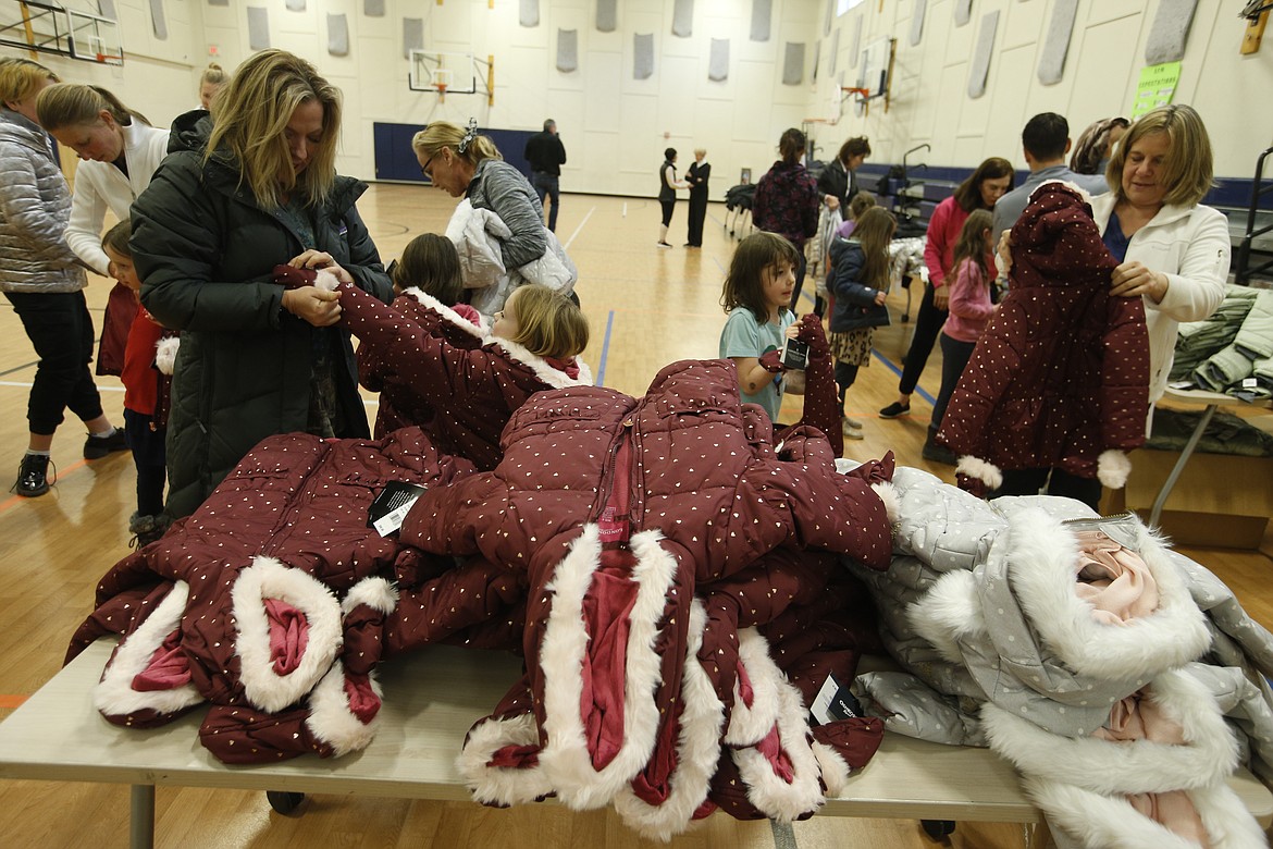 Coats are piled high on tables at the Duane and Lola Hagadone Boys and Girls Club on Thursday