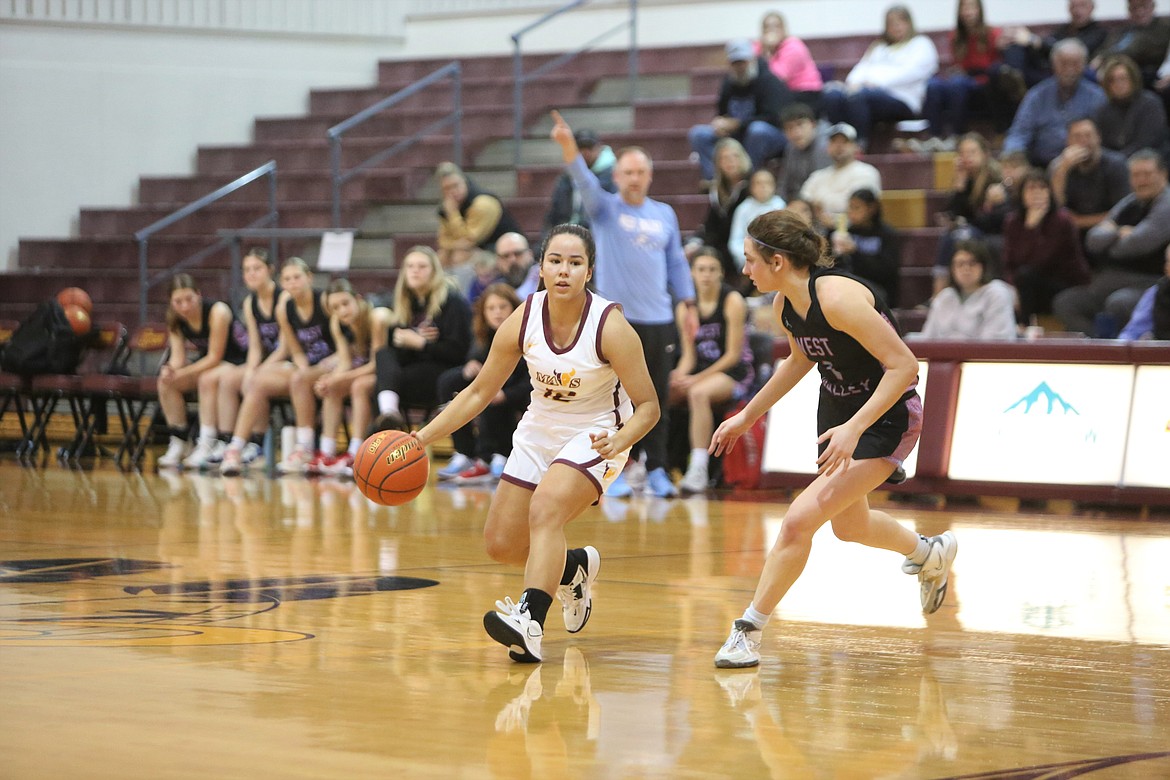 Moses Lake senior Marissa Bischoff, left, moves the ball up the floor against West Valley (Yakima) in the first round of the Columbia Basin Big 9 district tournament. Head Coach Matt Strophy credited Bischoff and teammate Lexi Cox for their defensive play in the Mav’s 47-45 win over Eisenhower on Thursday.