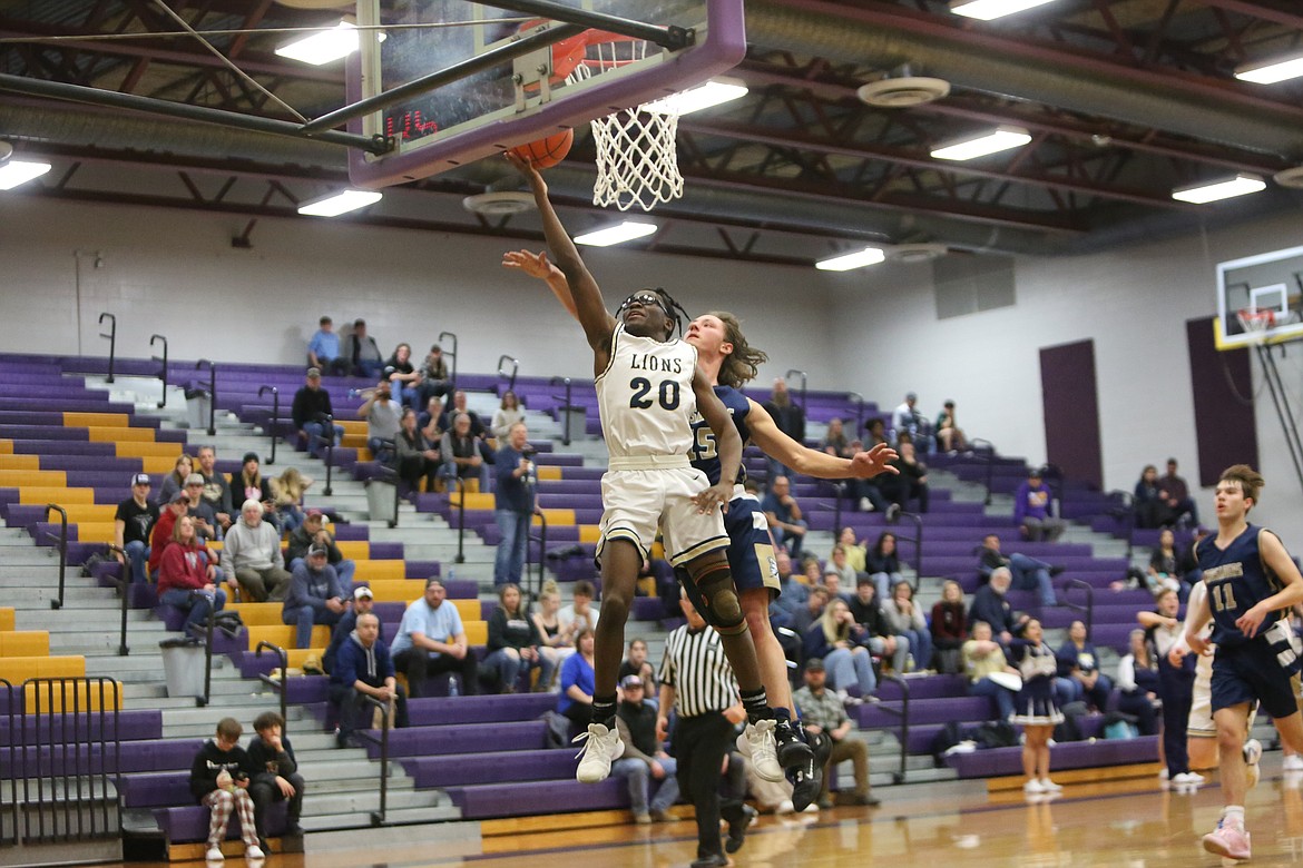 MLCA/CCS senior Jeff Boorman (20) leaps up for a layup against Riverside Christian in Thursday’s Central Washington 1B championship game. Boorman scored 30 points in the win, 24 of which came in the second half.