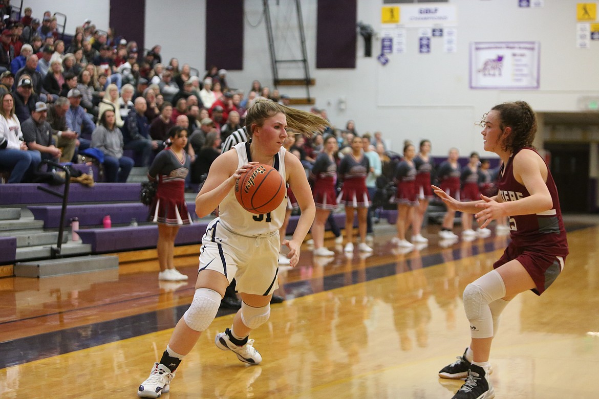 MLCS/CCS senior Makiya Kast, left, drives to the rim in the second half against Waterville-Mansfield in the Central Washington 1B district championship game.