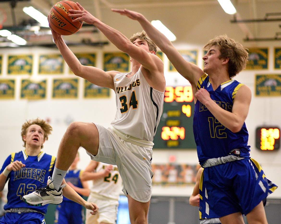 Bulldog Scotty Dalen makes a shot over a Logger defender in a game against Libby on Saturday in Whitefish. (Whitney England/Whitefish Pilot)