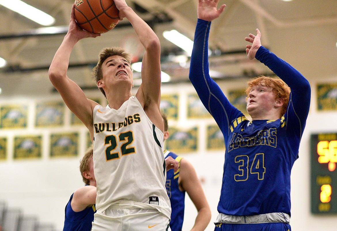 Whitefish's Carson Krack nabs a rebound for a put-back shot against Libby on Saturday in Whitefish. (Whitney England/Whitefish Pilot)