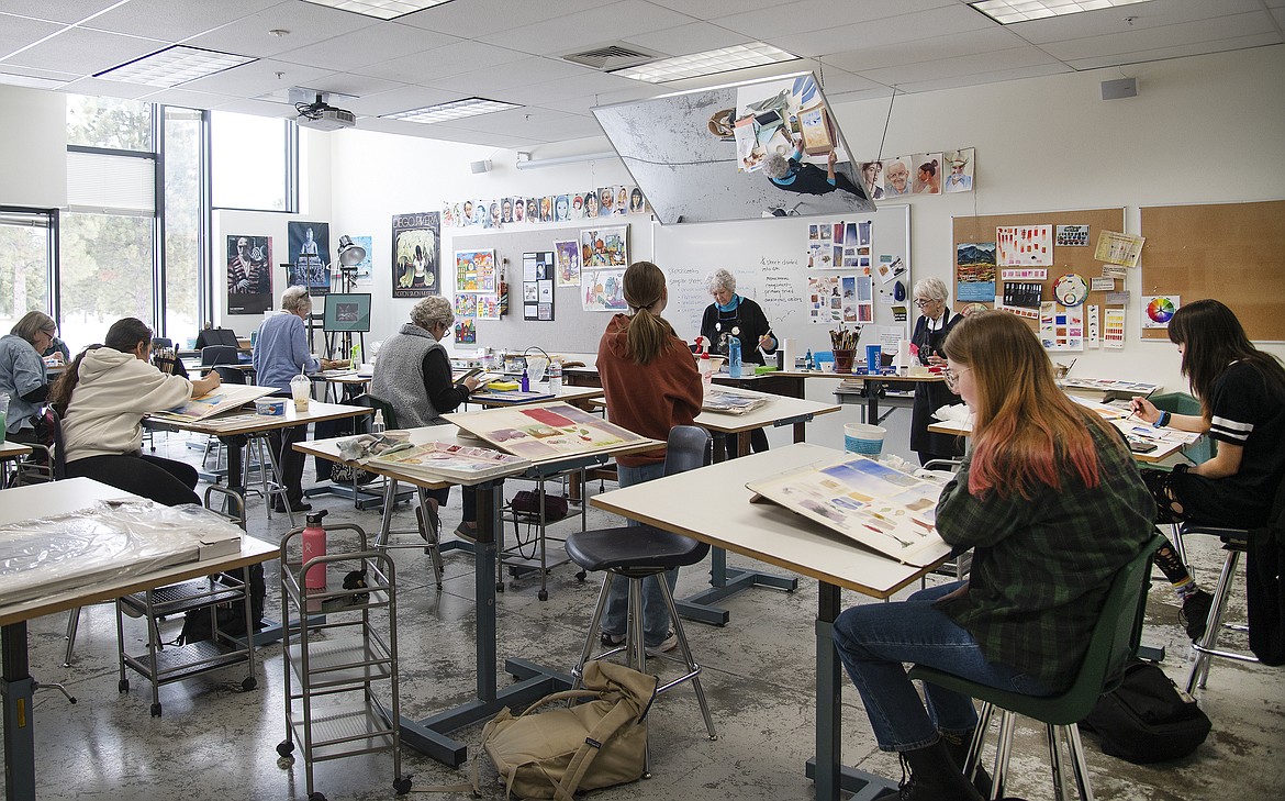 Flathead Valley Community College art instructor Karen Leigh works with students in the classroom. (Photo courtesy of FVCC)