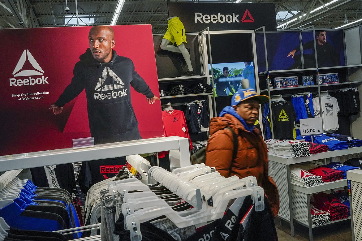 A man walks past a Reebok display at the Walmart Supercenter in North Bergen, N.J., on Thursday, Feb. 9, 2023. Defying high inflation and sharp interest rate hikes, Americans keep spending — a trend that, if sustained, could keep the economy humming just enough to help avoid a much-predicted recession. (AP Photo/Eduardo Munoz Alvarez)