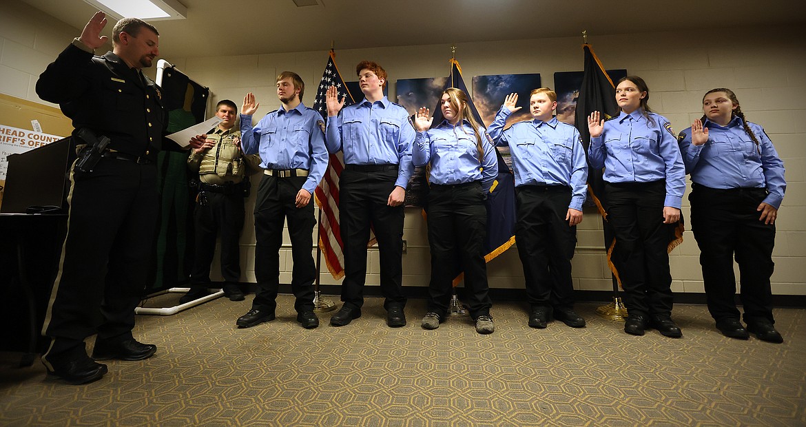 Flathead County Sheriff Brian Heino, along with program advisor Michael Hingiss, swear in the first members of the Flathead County Sheriff's Office Explorer Program Feb. 13. (Jeremy Weber/Daily Inter Lake)