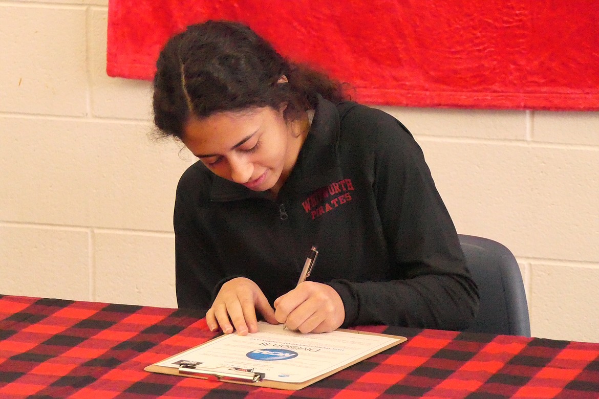 Isabella Pereira signs her track and field scholarship letter of intent during a signing ceremony this past Tuesday in Superior. (Chuck Bandel/MI-VP)