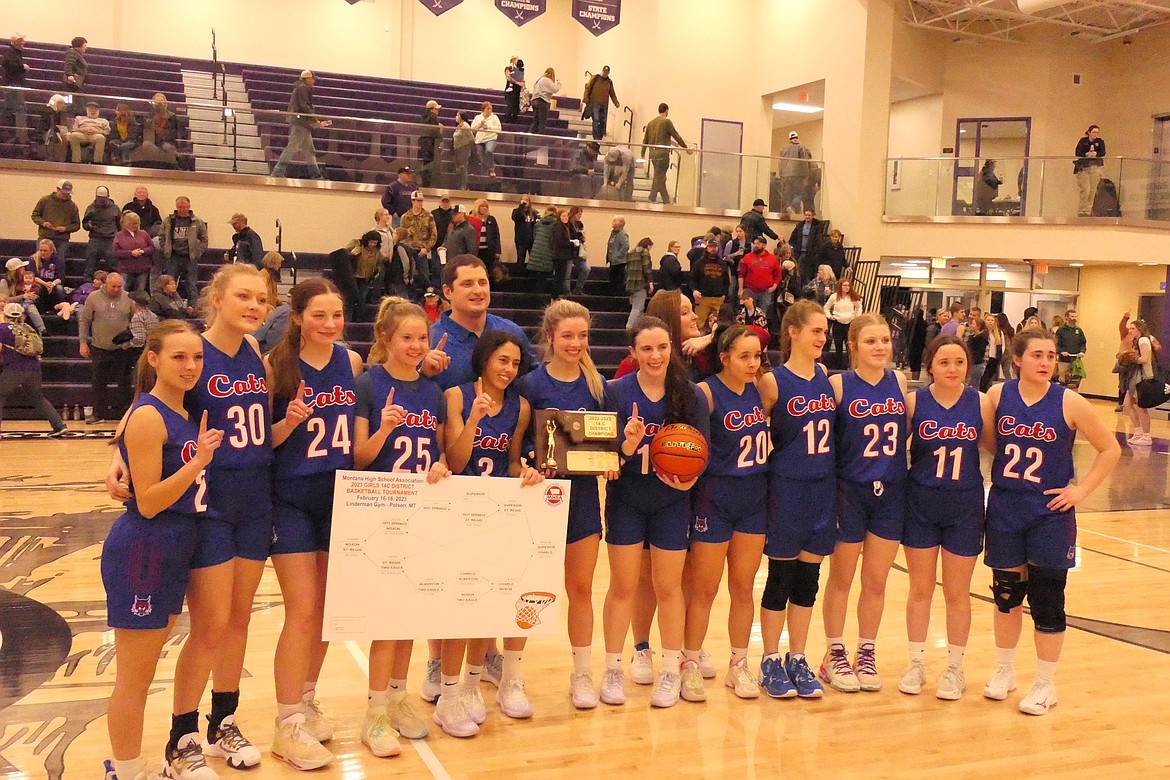 Superior's Lady Bobcats pose with their trophy and placard following their championship win over Charlo in the Western 14C tournament Saturday night in Polson. (Chuck Bandel/VP-MI)