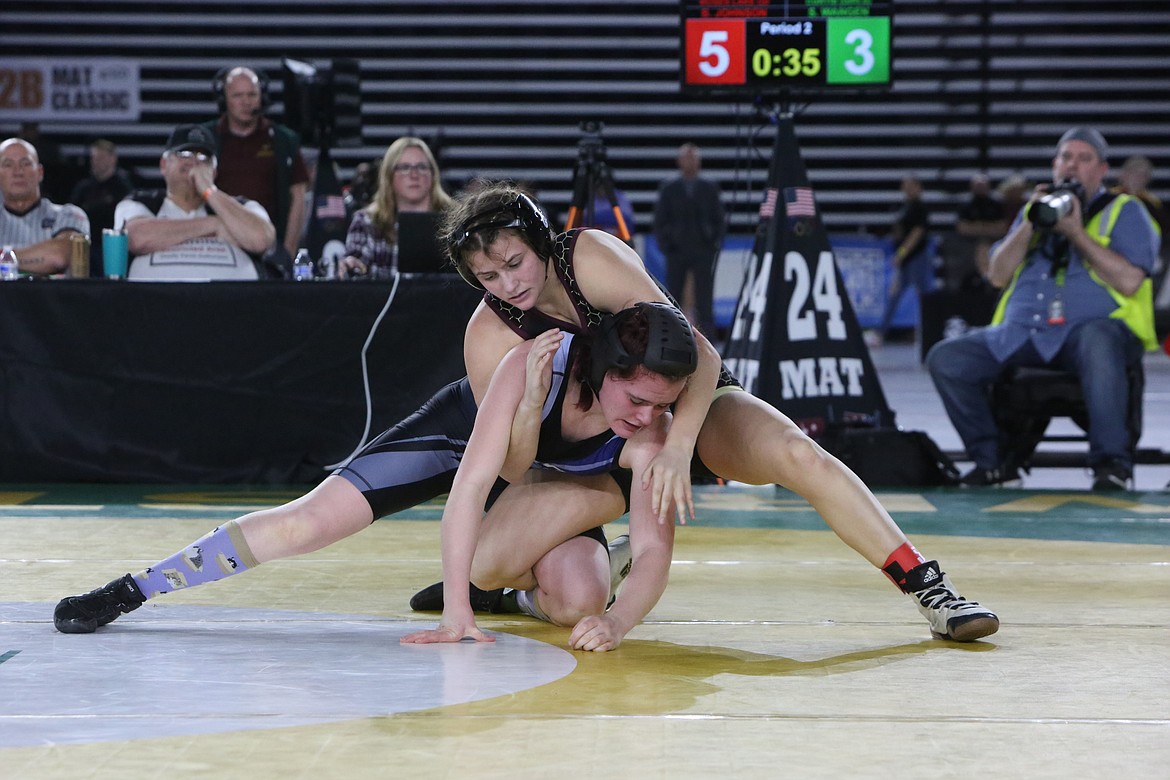 Moses Lake senior Bianca Johnson, top, works against her opponent, Sierra Wangen of Curtis, in the 130-pound finals at the Girls 3A/4A Mat Classic.