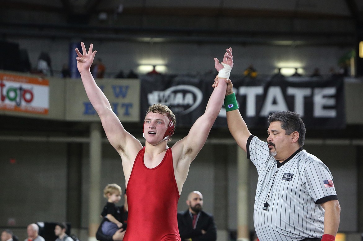 With his arms raised in victory, Othello senior Terrill Freeman, left, celebrates after winning the 195-pound finals match over Orting’s Hunter Sonnenberg at the Mat Classic in Tacoma.