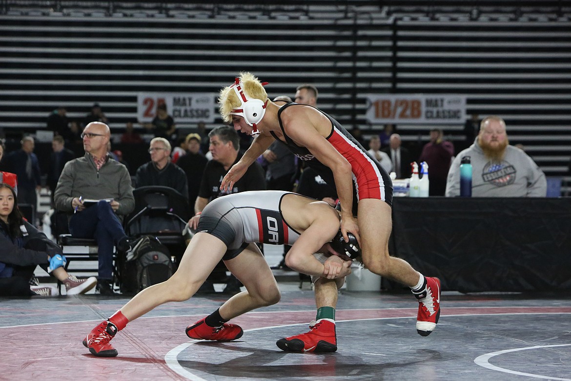 Othello junior Isaac Campos, right, placed second in the 113-pound bracket of the 2A Mat Classic at the Tacoma Dome over the weekend.