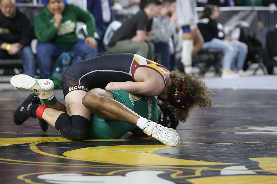 Moses Lake junior Dayton Regan, top, took fourth place in the 4A Boys 152-pound bracket of the Mat Classic.