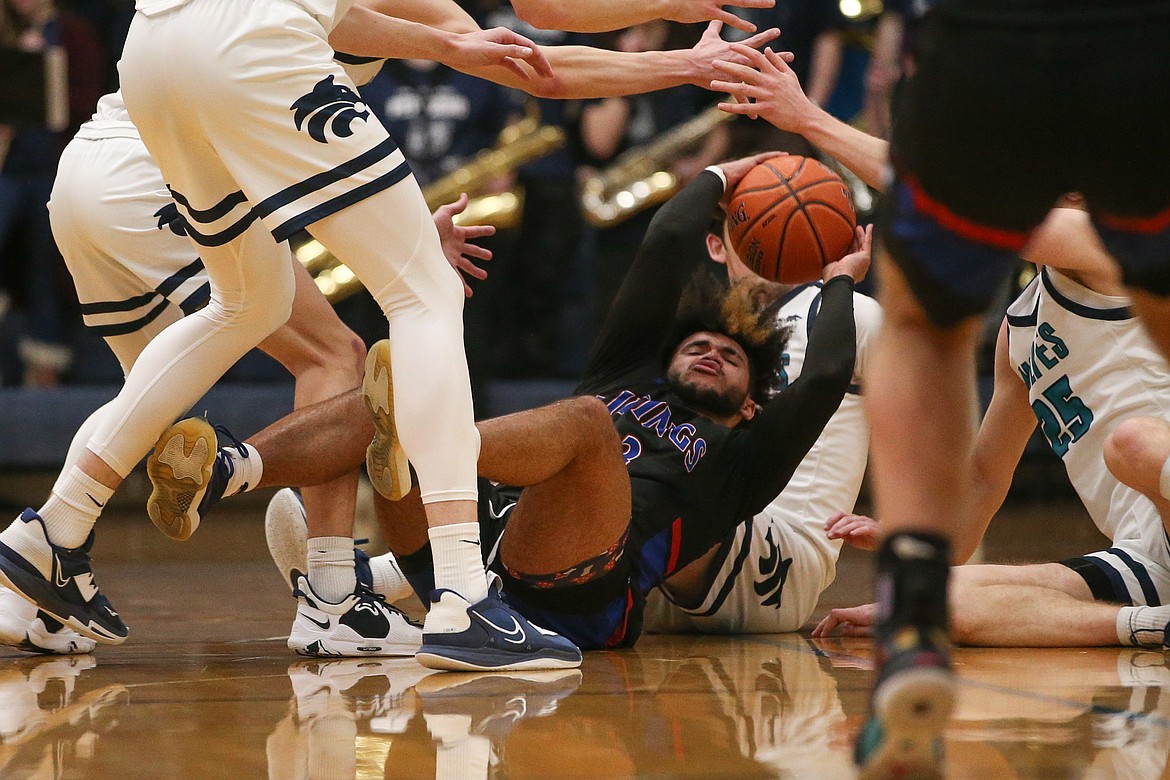 JASON DUCHOW PHOTOGRAPHY
Steven Burgess of Coeur d'Alene looks to get rid of the ball while surrounded by Lake City players in Tuesday night's 5A Region 1 championship game.