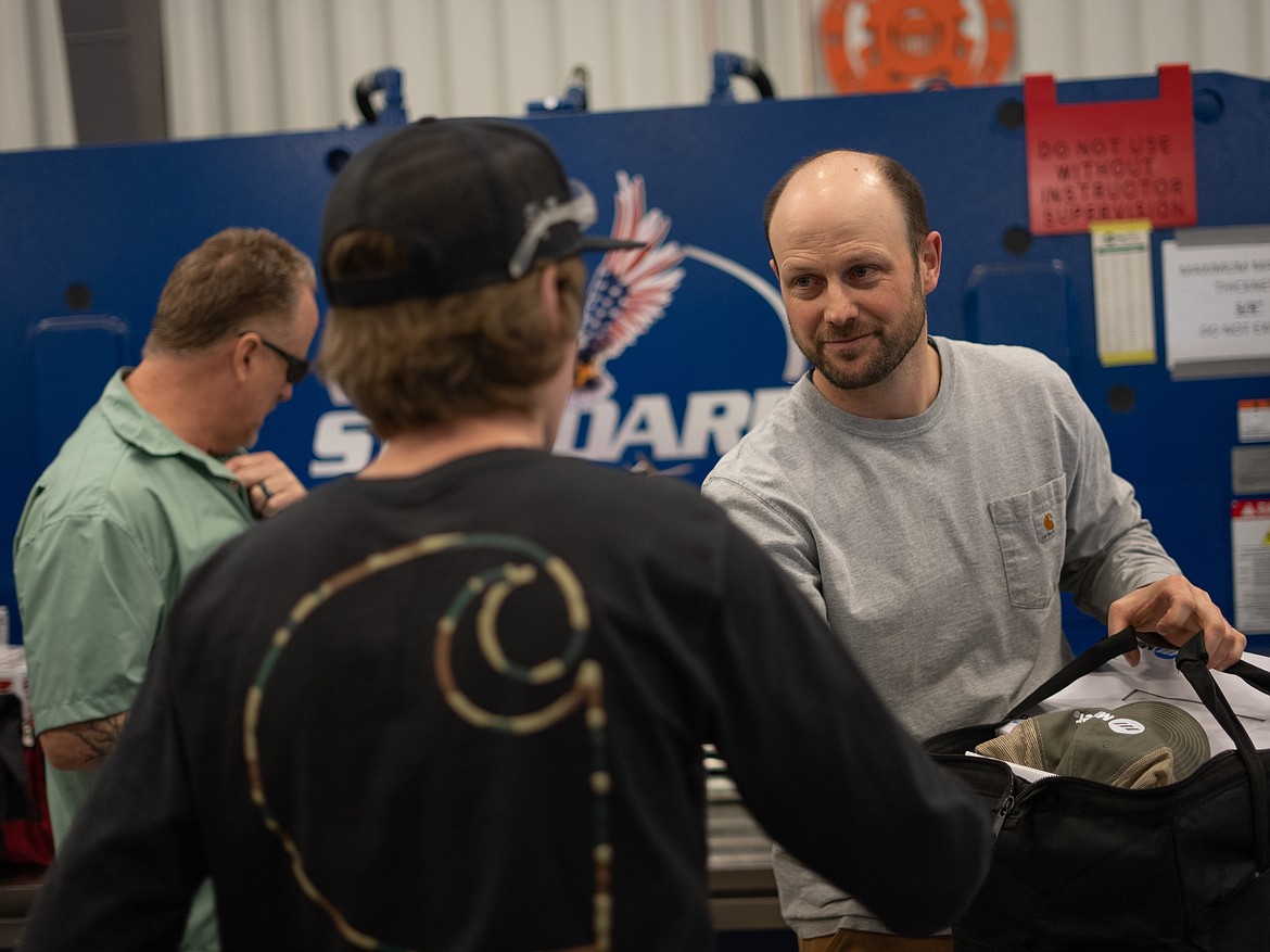 Welding Technology Associate Professor Earl Dreisbach, right, hands a student a prize in NIC’s annual welding skills competition on Friday, Feb. 10 at the Parker Technical Education Center in Rathdrum.