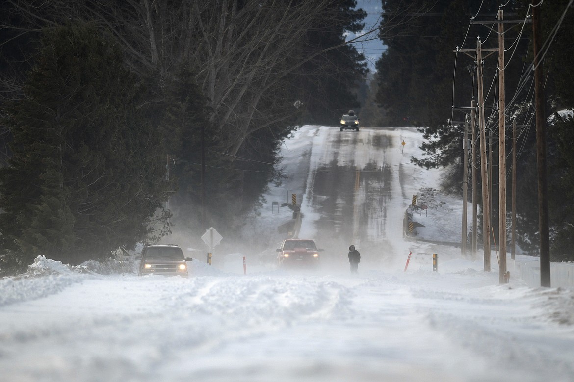 A vehicle is stuck in the snow along Hodgson Road after whiteout conditions caused Flathead County to close the stretch of road between Trumble Creek Road and the Whitefish River on Tuesday, Feb. 21. (Casey Kreider/Daily Inter Lake)