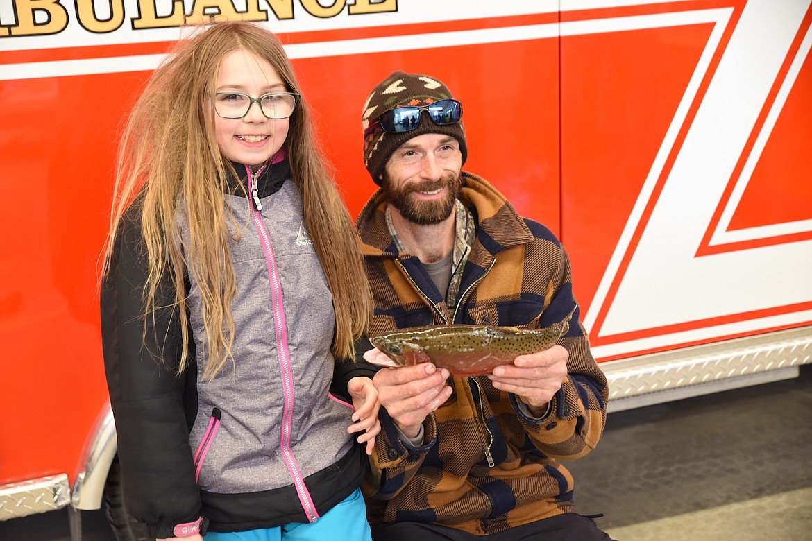 Allyson Myers and John Myers show off her one pound, 5.8 ounce rainbow trout during last weekend's Fisher River Valley Fire/Rescue Ice Fishing Derby. The trout measured 14 5/8 inches and was good for first place in the kids category. (Scott Shindledecker/The Western News)