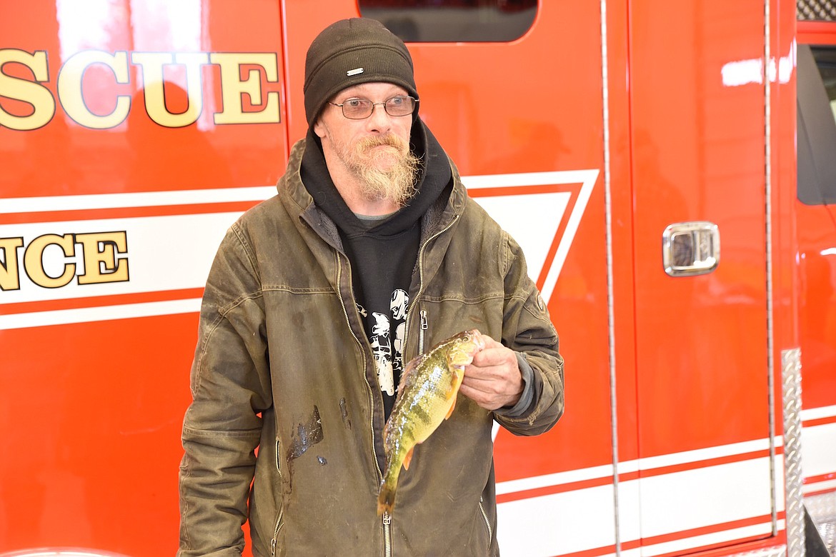 Mike Holmstrom's yellow perch weighed 14.7 ounces and measured 11 7/8 inches at last weekend's Fisher River Valley Fire/Rescue Ice Fishing Derby. The perch placed second in the adult category. (Scott Shindledecker/The Western News)