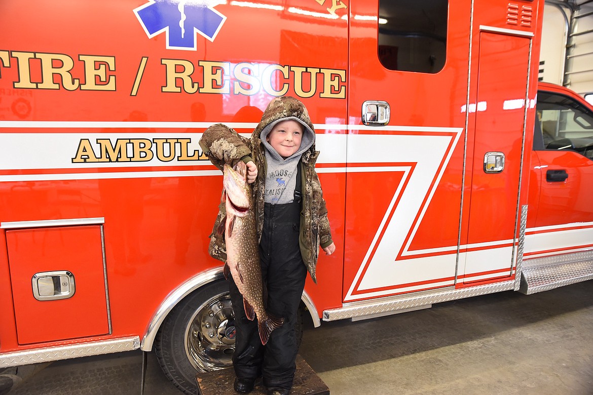 Angler Reid Schlegel is all smiles as he hoists an eight pound, 6.7 ounce northern pike he caught during last weekend's Fisher River Valley Fire/Rescue Ice Fishing Derby. The toothy predator measured 30 3/4 inches and placed first in the kids category. Schlegel also landed a one pound, 5.6 ounce rainbow trout, good for second place. (Scott Shindledecker/The Western News)