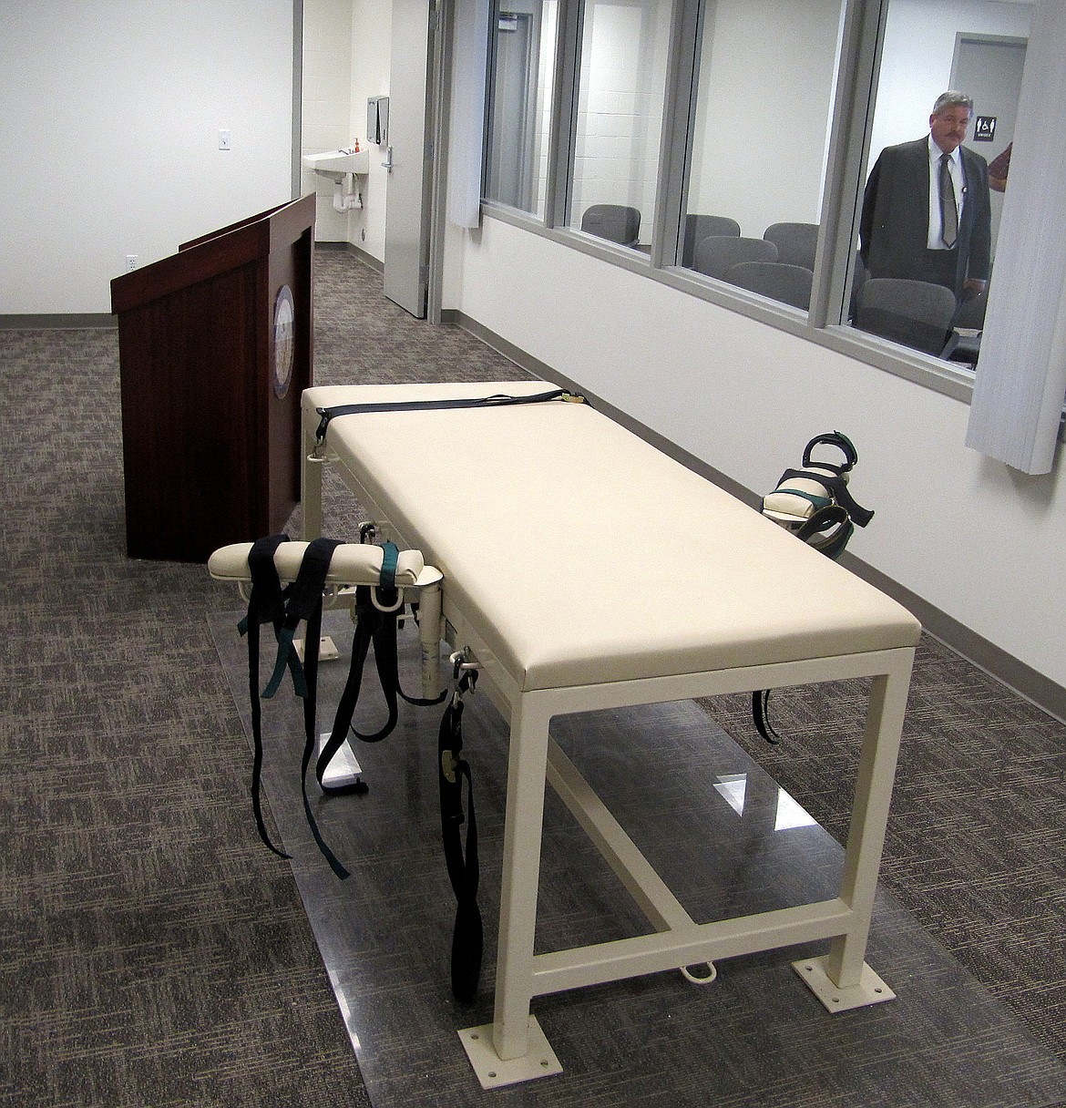 In this Oct. 20, 2011 file photo, the execution chamber at the Idaho Maximum Security Institution is shown as Security Institution Warden Randy Blades look on in Boise, Idaho. Idaho could bring back firing squads as a method of execution under legislation introduced by a panel of lawmakers Wednesday, Feb. 22, 2023. (AP Photo/Jessie L. Bonner, File)