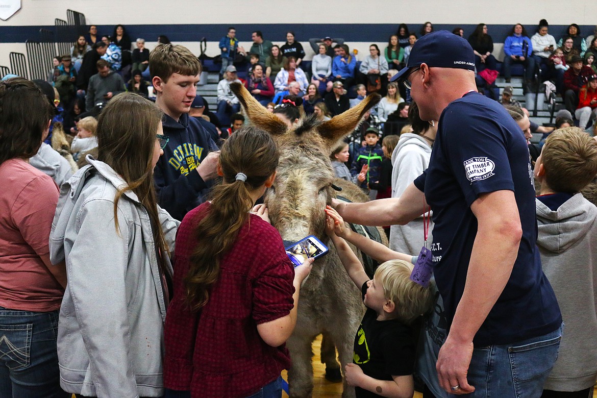 Community members interact with donkeys at half time.