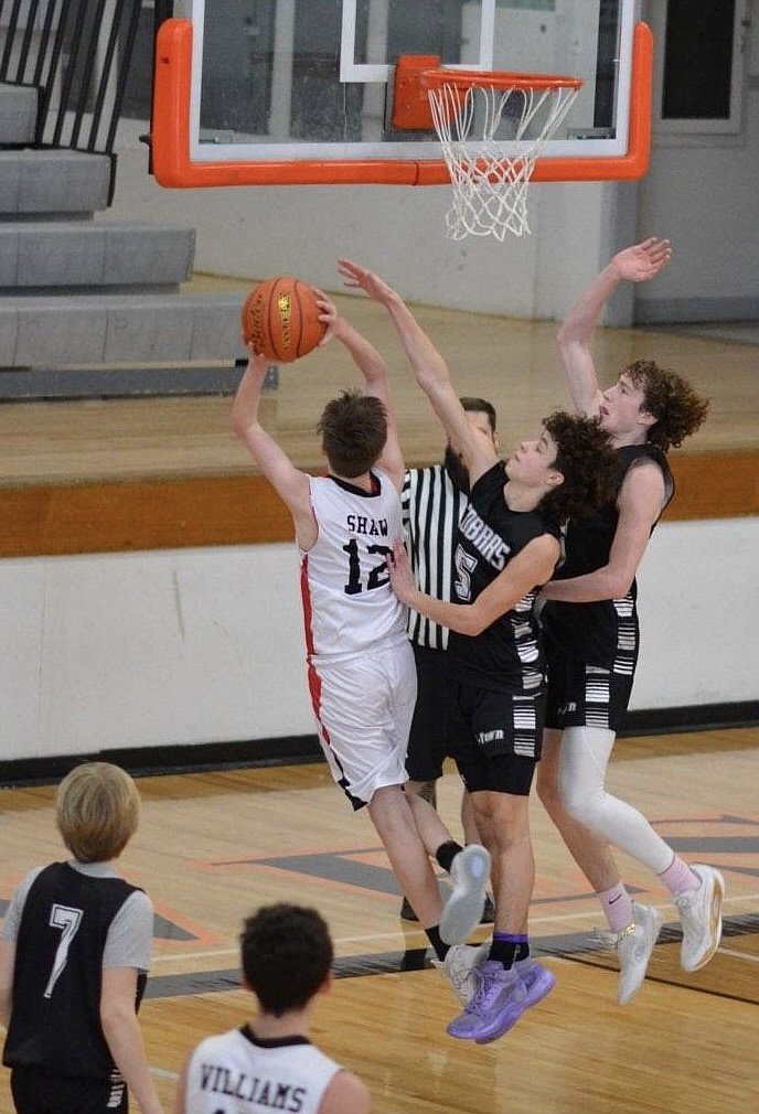 Sandpoint Future 8th Grade Boys player, Brennan Shaw, draws a foul against the Kalispell Cobras.