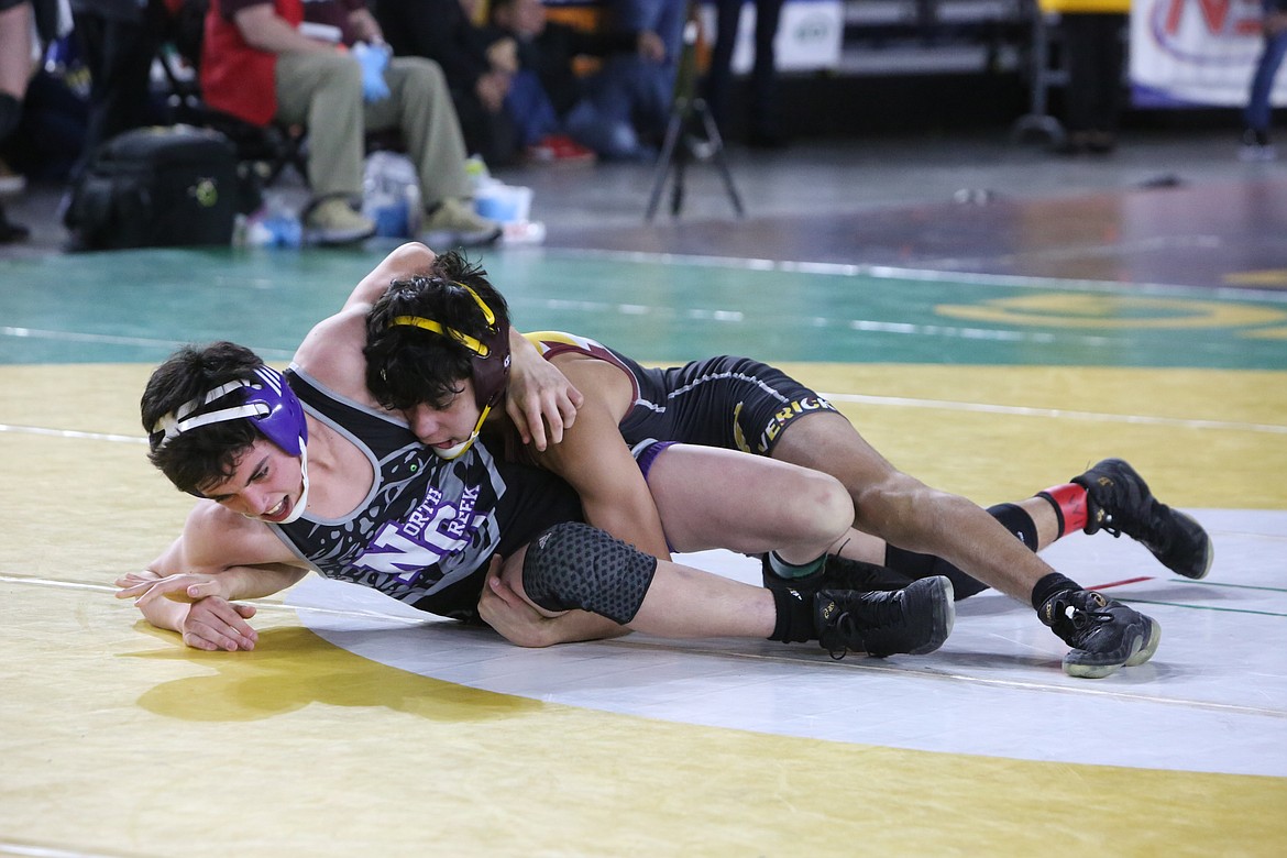 Moses Lake freshman Ian Garza, top, wrestles against North Creek freshman Colton Johnson in the 4A 106-pound bracket of the 2023 Mat Classic in Tacoma.