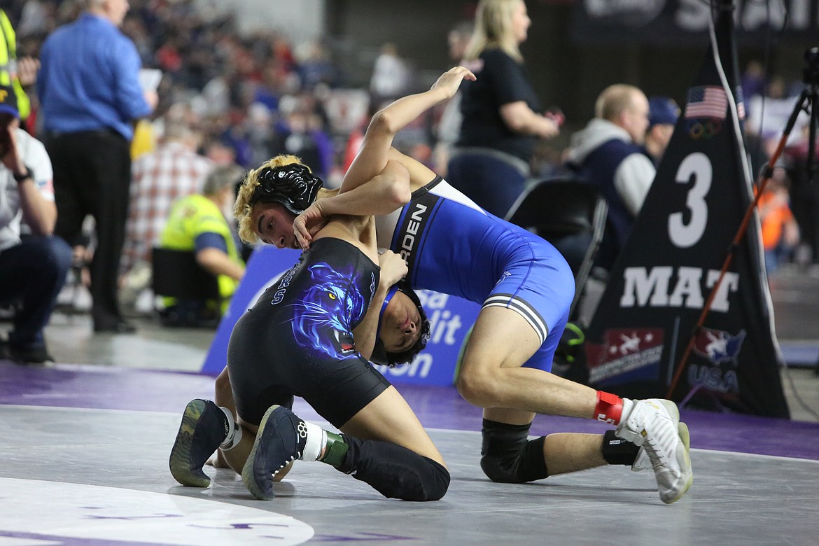 Warden senior Gio Castro, right, attempts to flip his opponent, Miguel Depaz of Tonasket, onto his back in the second round of the 2B/1B 106-pound consolation bracket.