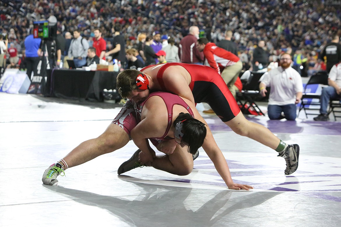 Lind-Ritzville/Sprague sophomore Brock Tracy, top, pushed Okanogan senior Joseph Cates to the ground in the second round of the Boys 2B/1B 285-pound bracket at the Mat Classic.