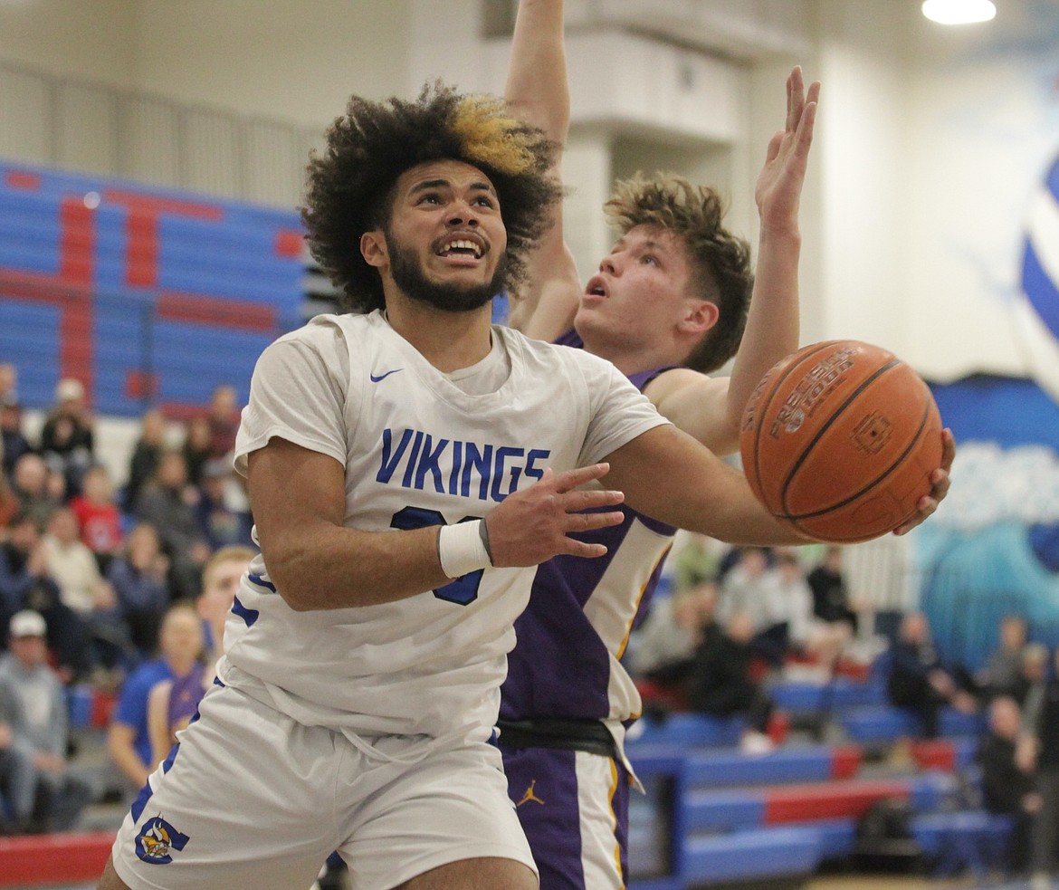 MARK NELKE/Press
Steven Burgess (23) of Coeur d'Alene goes up for a shot against Lewiston in the second-place game of the 5A Region 1 tournament Thursday night at Coeur d'Alene High.