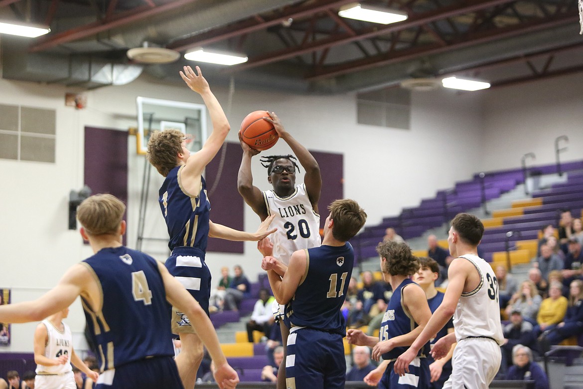 MLCA/CCS senior Jeff Boorman (20) maneuvers through the Riverside Christian defense during the Lion’s 59-58 win over the Crusaders last week.