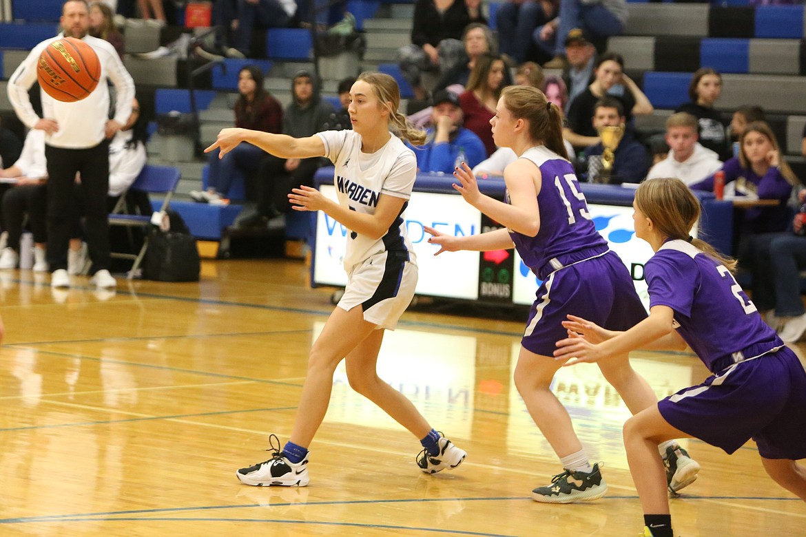 Warden senior Kaylee Erickson, left, passes the ball to a Cougar teammate during a game against Goldendale on Feb. 9.