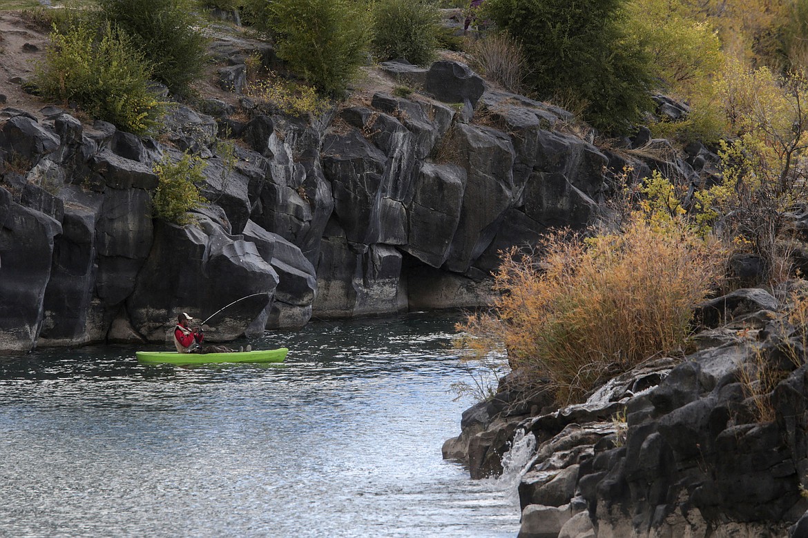 A man hooks a fish on the Snake River in Idaho Falls in mid-October 2020. Some top officials in Idaho are raising alarms over the Republican attorney general’s decision not to join a 24-state lawsuit against new waterway protections by the Biden administration. Instead, the state will be joining another lawsuit filed in Texas, which Idaho Attorney General Raul Labrador’s office says is a better fit for his state's interests.