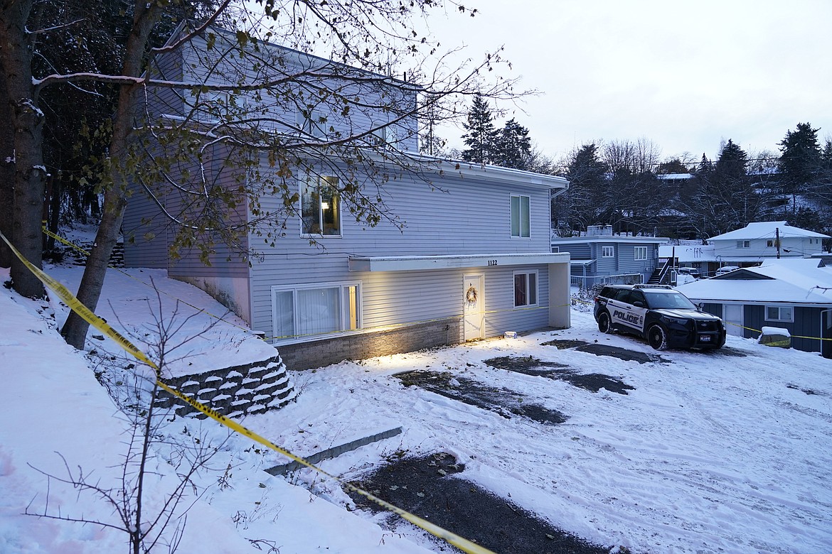 Bare spots are seen on Nov. 29, 2022, in the snowy parking lot in front of the home where four University of Idaho students were found dead on Nov. 13, in Moscow, after vehicles belonging to the victims and others were towed away earlier in the day.