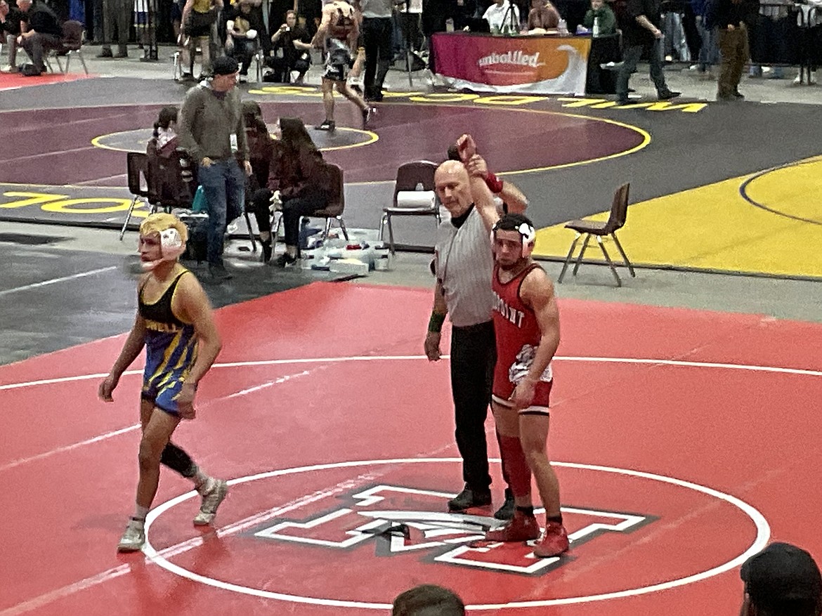 Sandpoint High School's Ashlei Hawkins is declared the winner of a match on the opening day of the state wrestling tournament on Thursday. He will compete in the semi-final match on Friday.