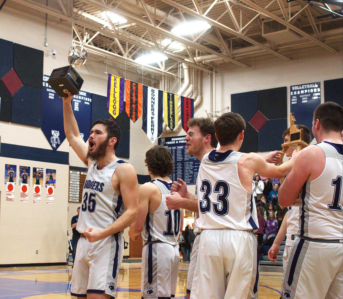 Braeden Blackmore shows the district trophy to the crowd.