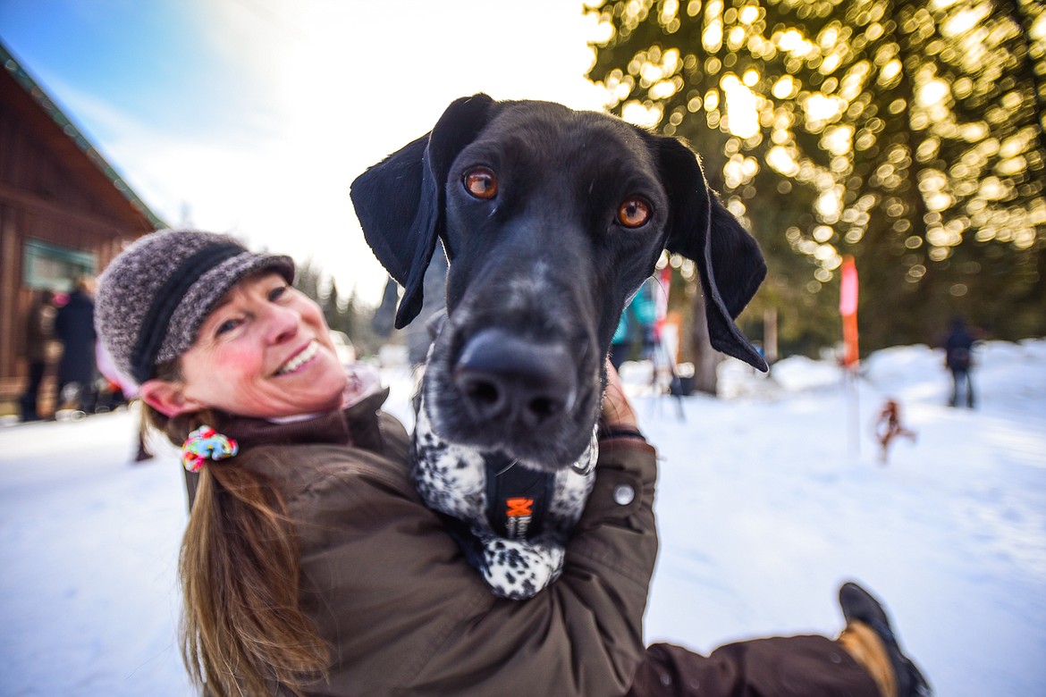 Kathy Luedtke holds Robin, a German shorthair belonging to her friend Teresa Petterson, before the start of the one-dog skijor races at the Flathead Classic Sled Dog Races at Dog Creek Lodge and Nordic Center in Olney on Saturday, Feb. 25. (Casey Kreider/Daily Inter Lake)