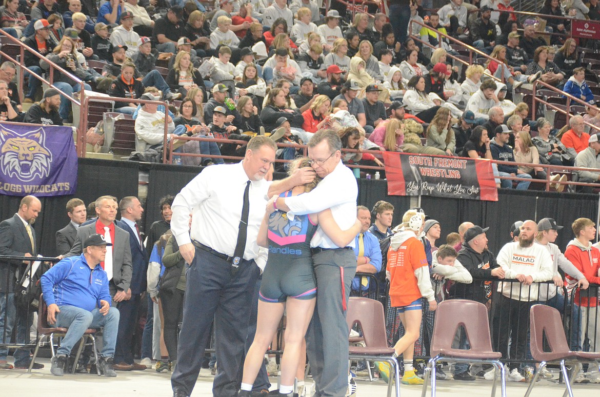 NORM SEE/Special to Hagadone News Network
Senior Alyssa Randles of Coeur d'Alene hugs her father, Coeur d'Alene High principal Mike Randles, as Coeur d'Alene wrestling coach Jeff Moffat, left, looks on after Alyssa won her fourth state girls wrestling title Saturday at the Ford Idaho Center in Nampa.