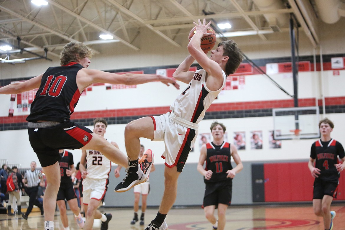 Lind-Ritzville/Sprague senior Hayden Melcher, right, fights through contact to make a shot near the end of the first half against Dayton-Waitsburg. Melcher was fouled on the shot, and made the ensuing free throw.