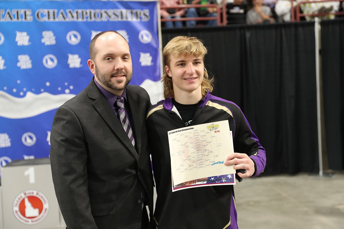 Jaeger Hall stands next to coach Travis Berti following Hall's podium ceremony at the Idaho State Wrestling Tournament. Hall won the tournament's 132-lb division.