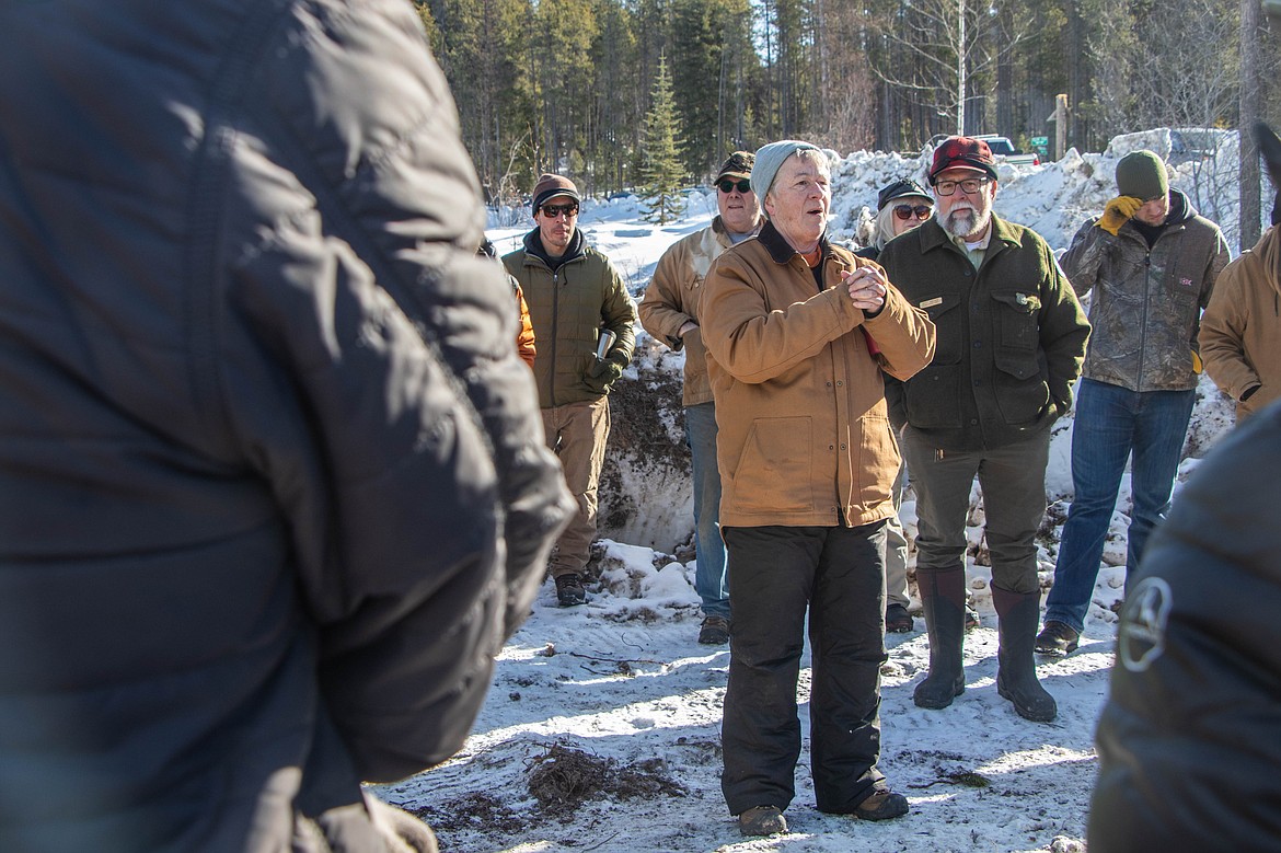 Debbie Page-Dumroese, a researcher with the USDA Forest Service Rocky Mountain Research Station, speaks during a presentation of the CharBoss near Coram on Feb. 16, 2023. Scott Snelson, a district ranger in the Spotted Bear Ranger District of the Flathead National Forest, stands behind her. (Kate Heston/Daily Inter Lake)